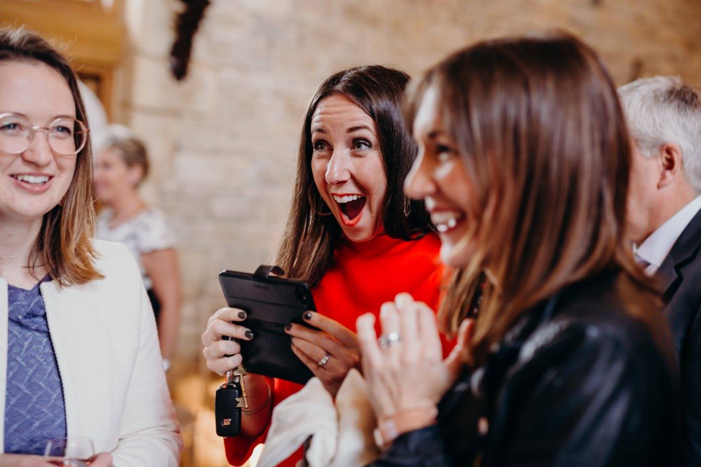 Woman in red shocked holding phone